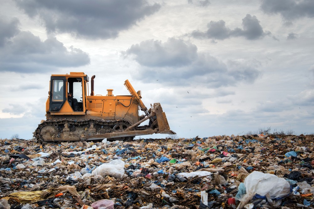 image of bulldozer on a waste landfill
