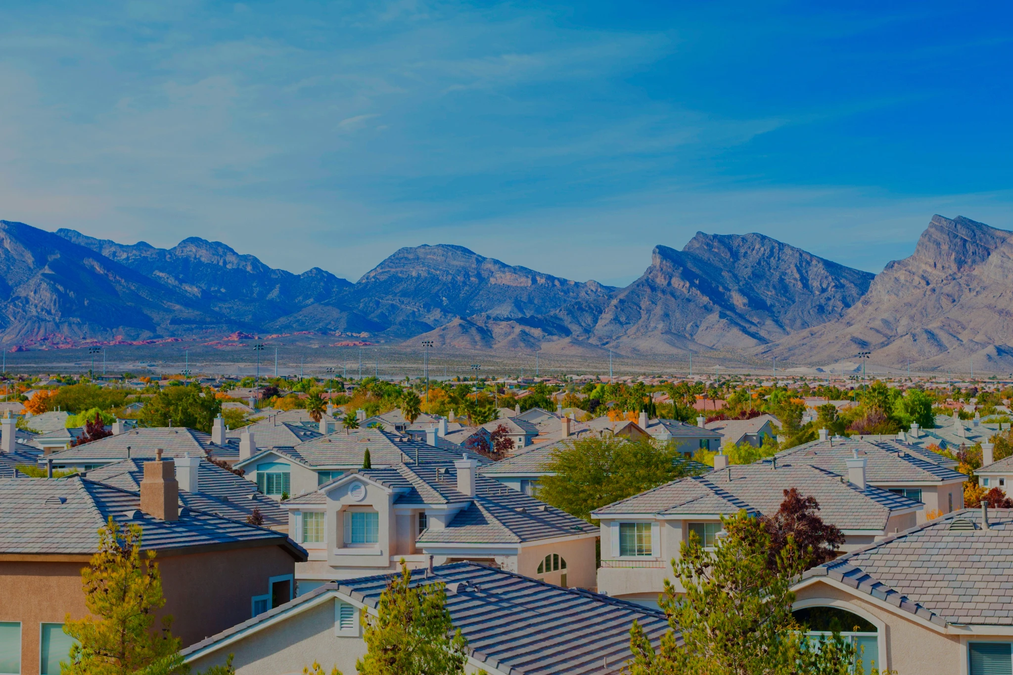 Las Vegas houses witroofs and mountains in the background
