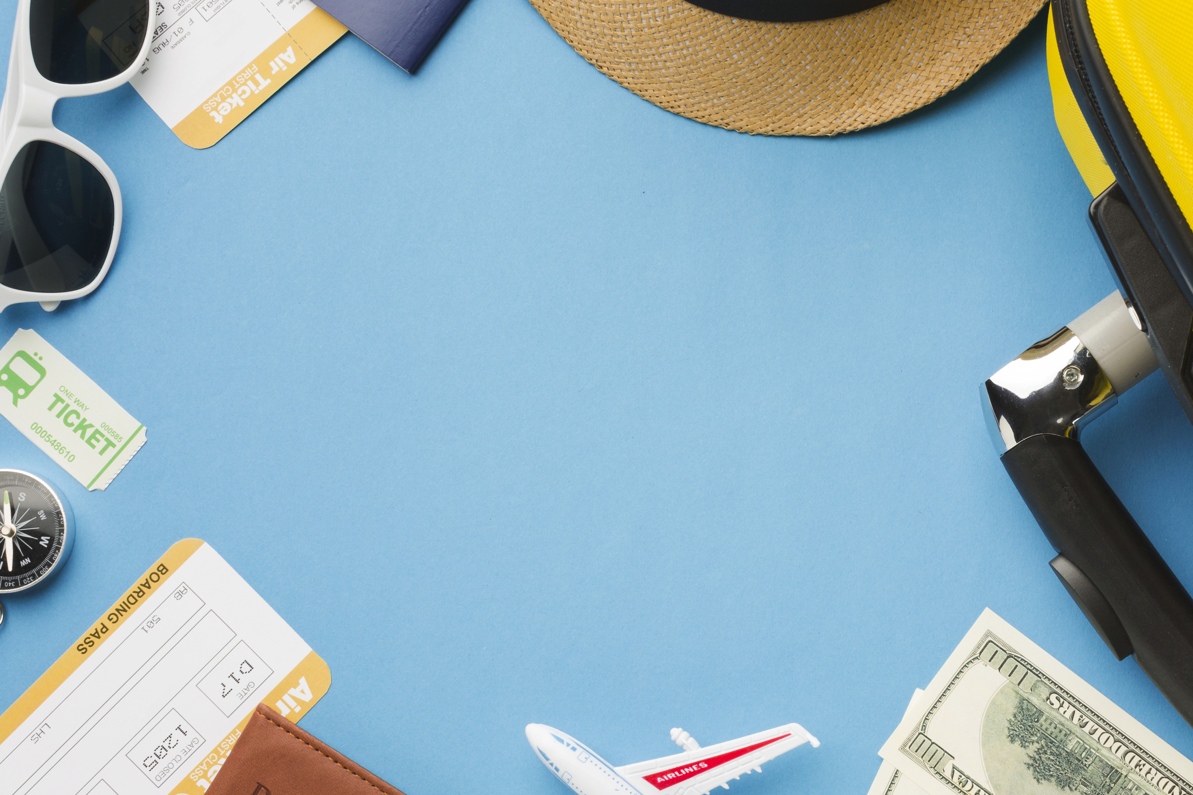 Landscape with a vineyard in rows leading to a building with a tower, rolling hills in the distance.
