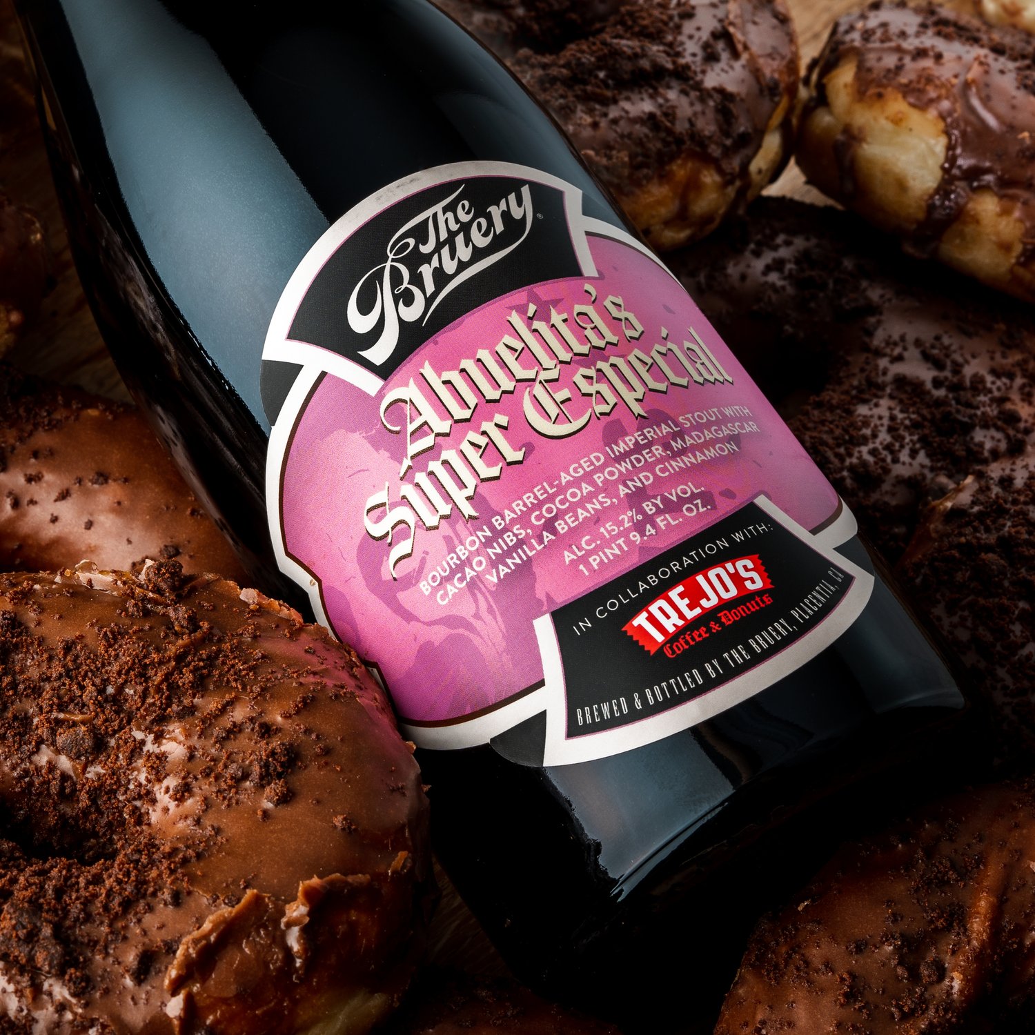 The Bruery beer bottle with pink label on donuts