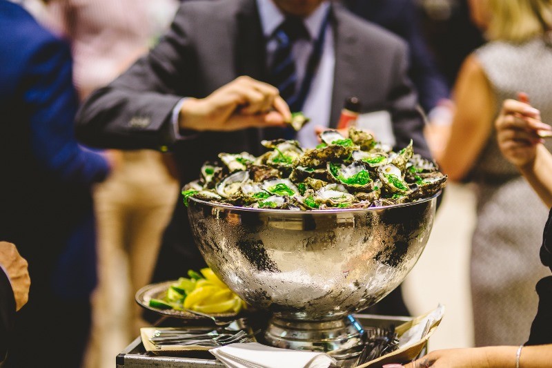 Guests partaking in the oyster station