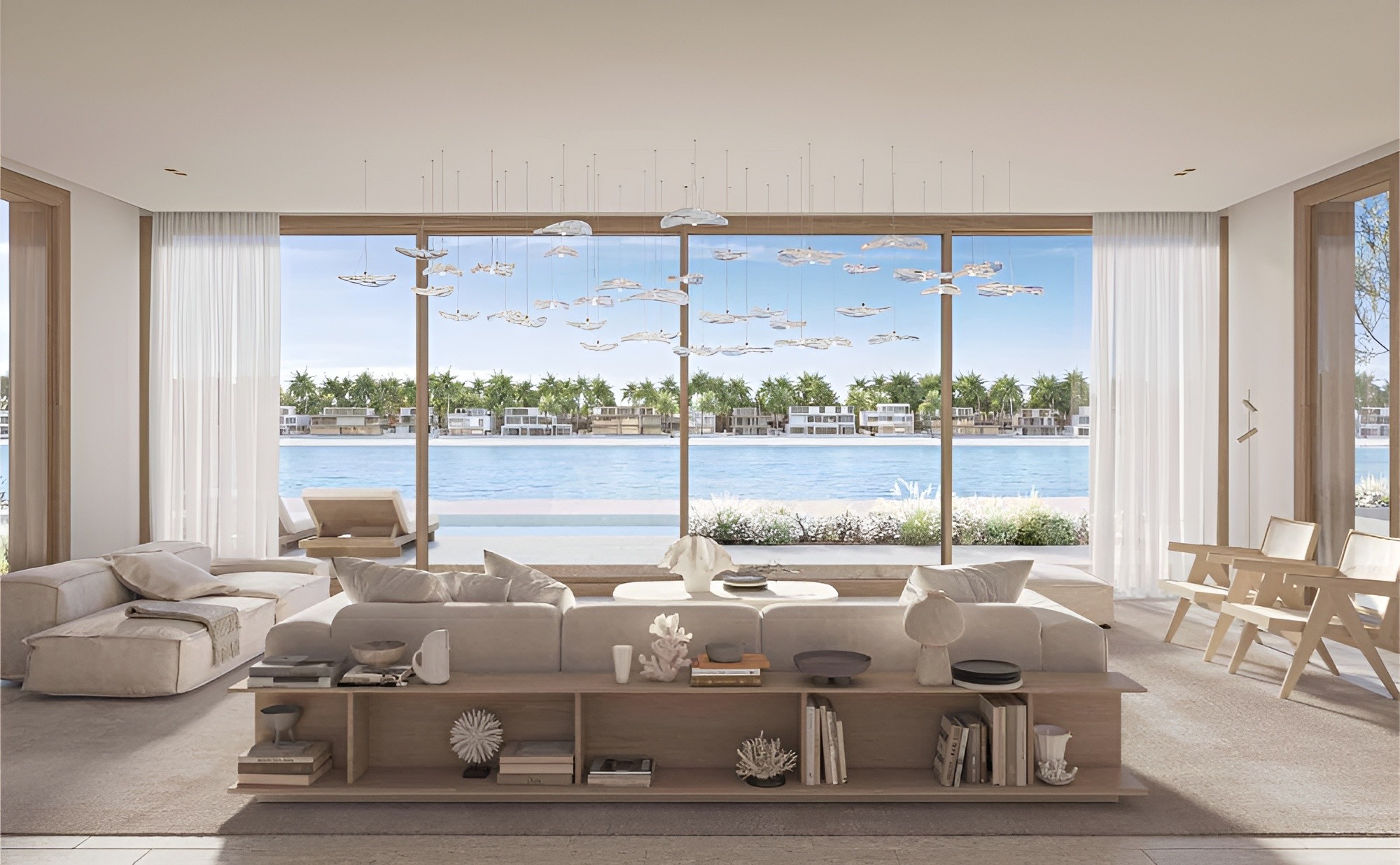 Contemporary living room with a spacious window offering a scenic view of the water, highlighting signature villas' design.