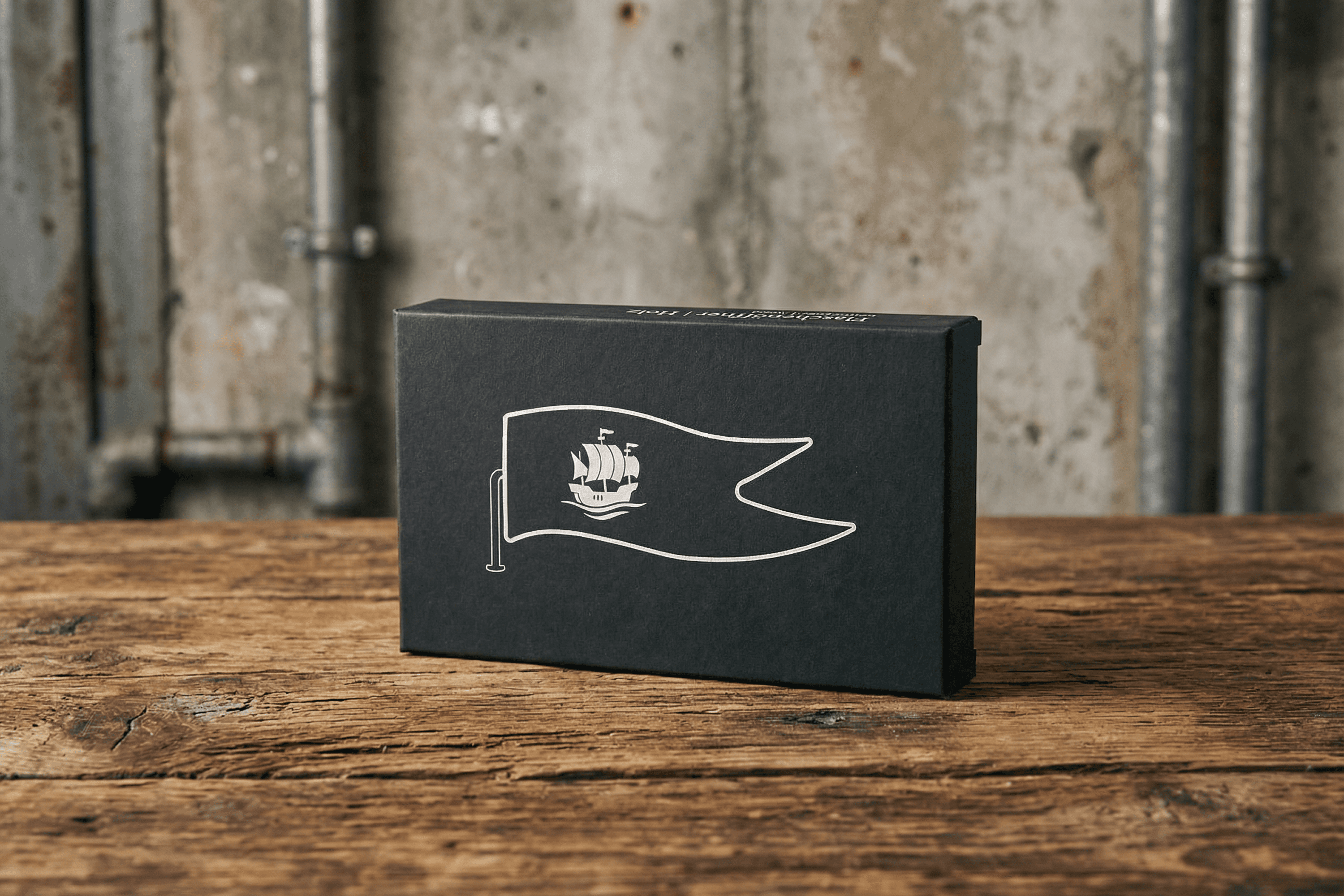 Black box with a white ship on a pennant graphic.