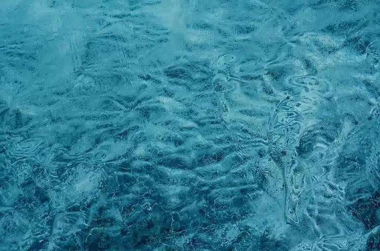 Abstract texture of deep blue glacial ice