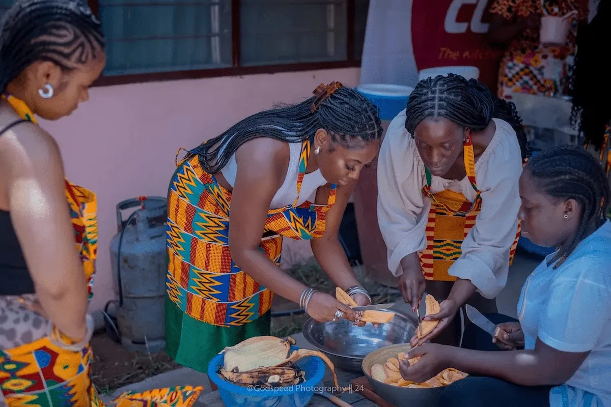 Travelers learn to peel and slice fresh plantains during a cooking class.