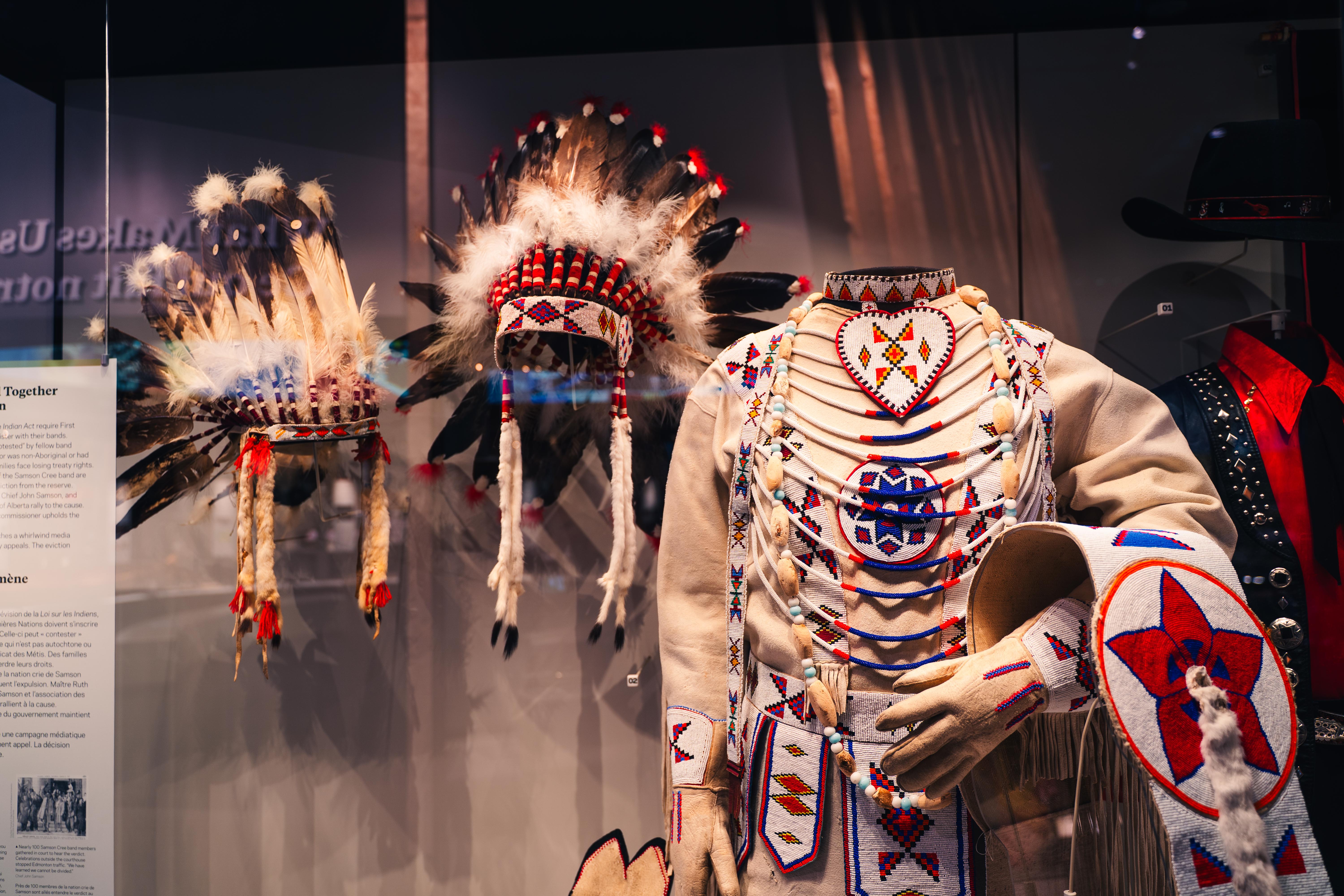 Aboriginal clothing being displayed in a museum behind glass