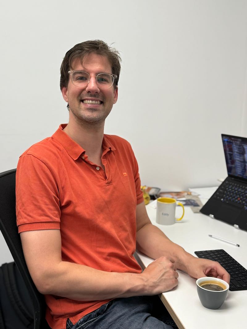 Two smiling women pose indoors at The Crate Hamilton.