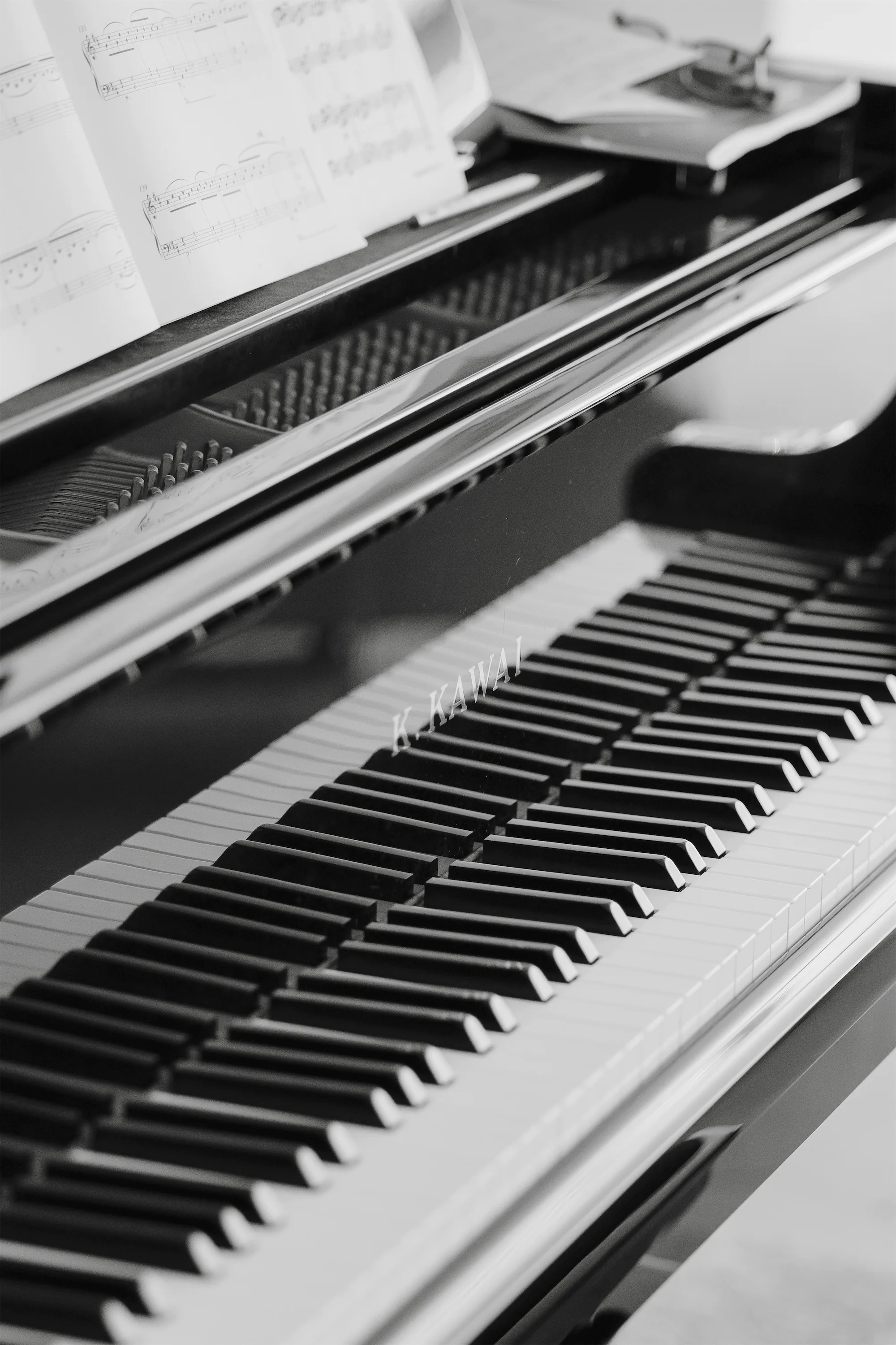 Cinematic black-and-white wedding photo of a piano during vows