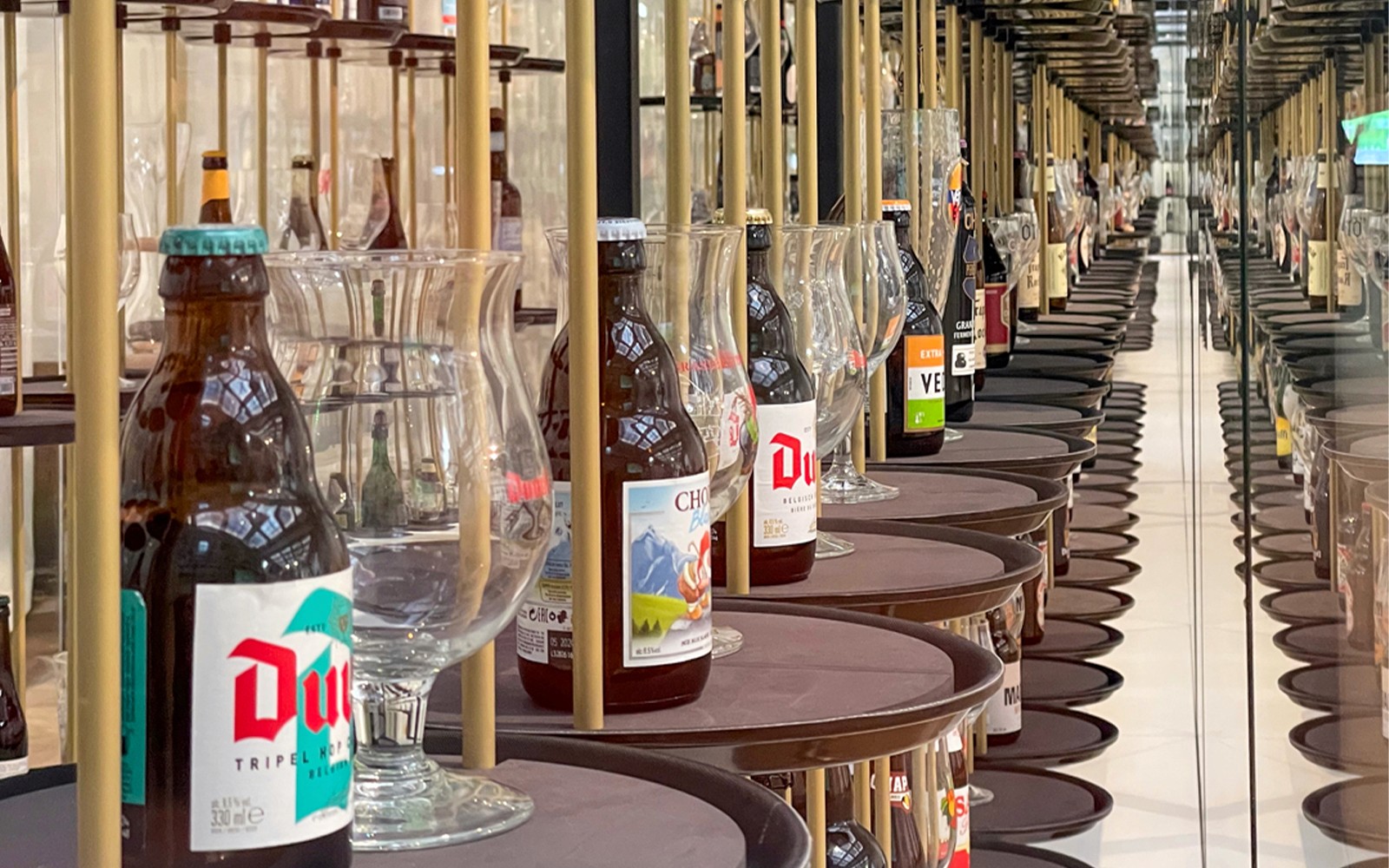 Belgian beer bottles and glasses displayed at Belgian Beer World, Brussels.