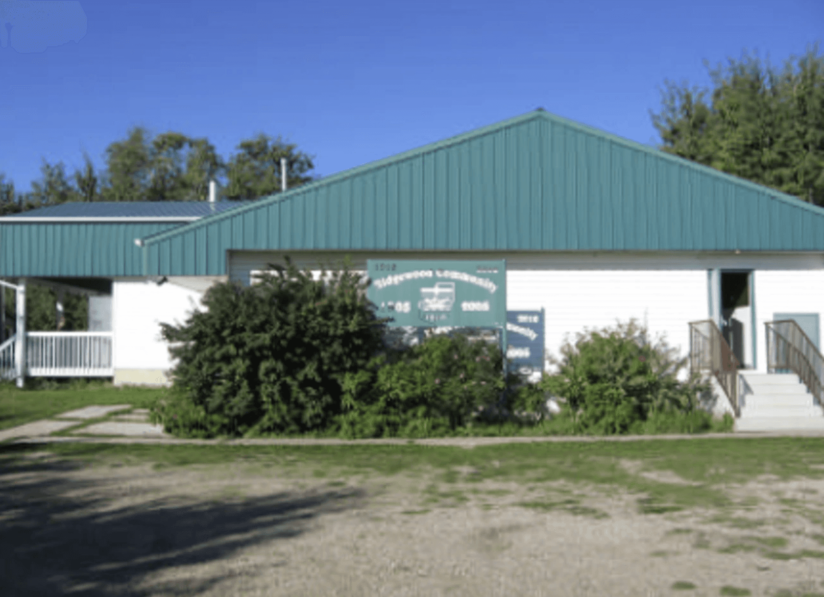 A couple embraces lovingly on a wooden dock.