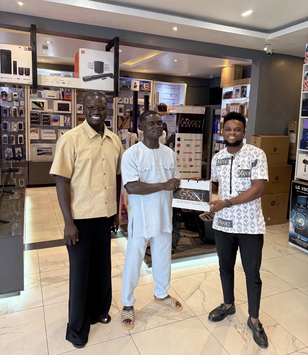 Two people sit across a table in a stylish room with red velvet walls and a large red pendant light. The mood is intimate and modern.