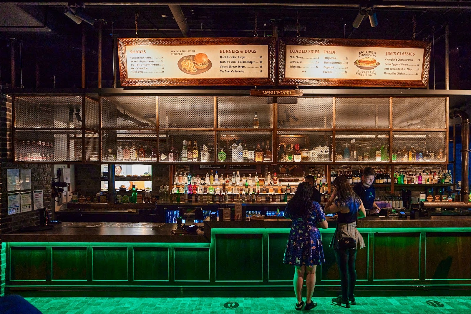 A group of people playing billards on a pool table in the 2315 Bar at Fortress
