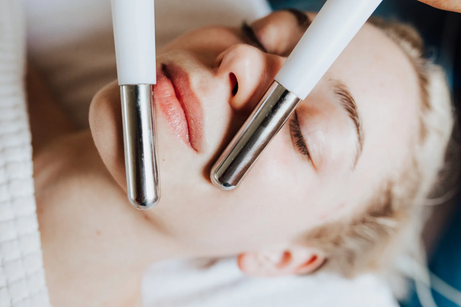 Cosmetologist performing a facial treatment on a client in a spa clinic