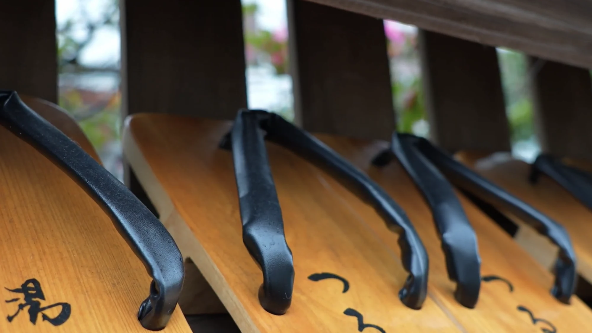 The underside of a wooden geta sandal marked with the character for hot water.