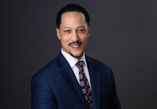 A couple of men standing next to each other on a beach