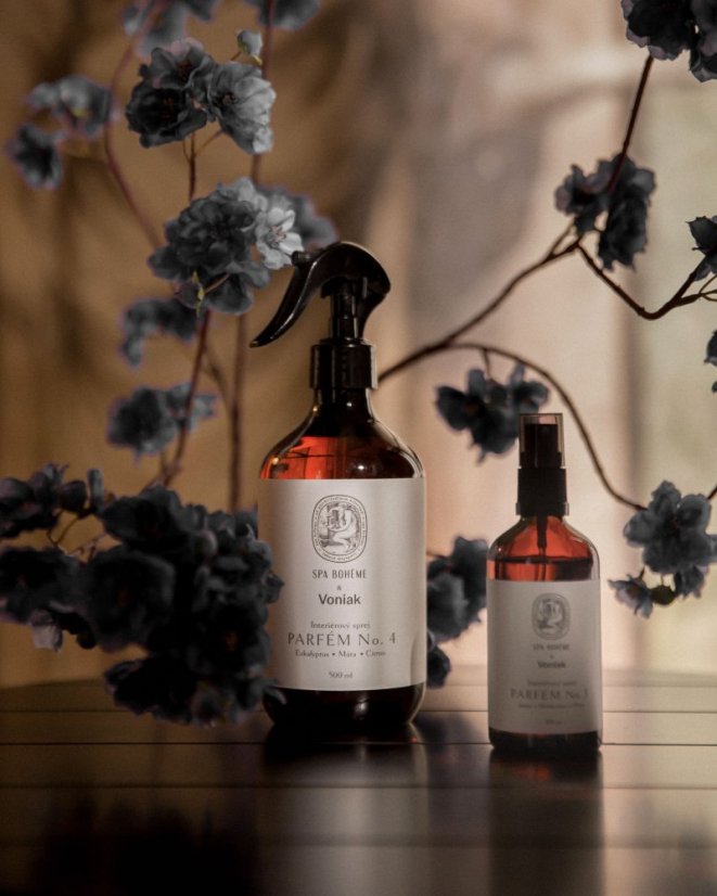 Close-up of a woman resting on a horse’s back under natural sunlight, wearing a black top and gold twisted bracelet.