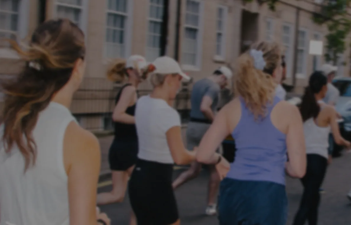 A group of women running together along a city street