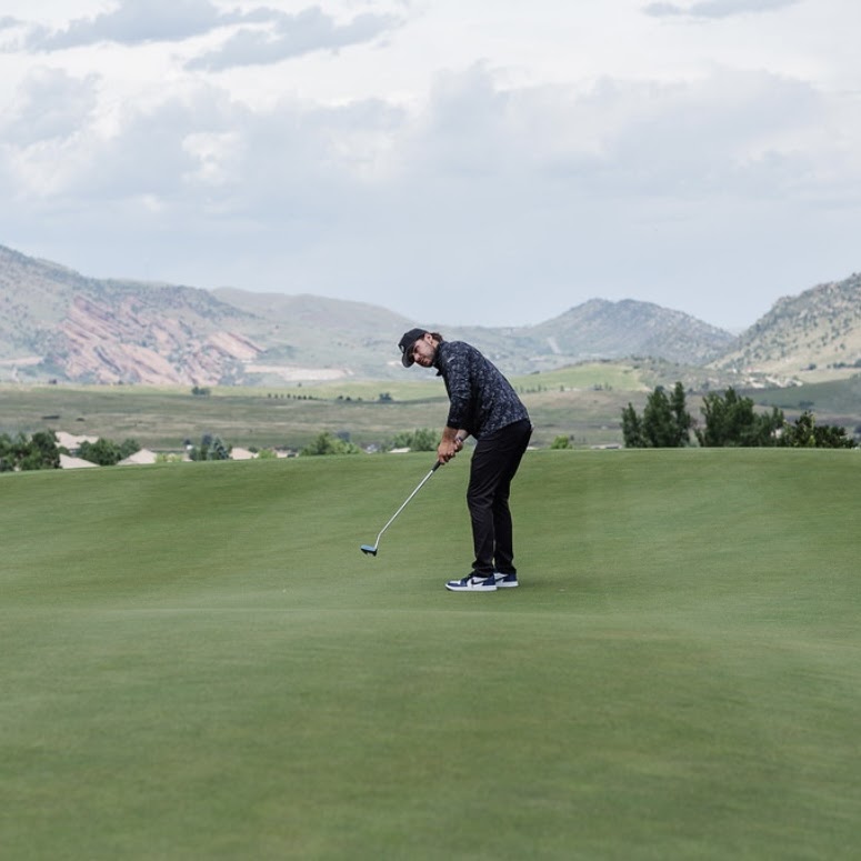Jax finishing his swing with a putter.