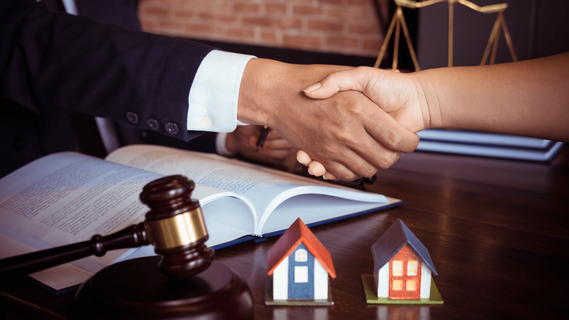 Landlord finalising a company let agreement with legal documents and property models, showcasing how TenantMarket connects landlords with reliable company tenants amid Rent Reform Act changes.