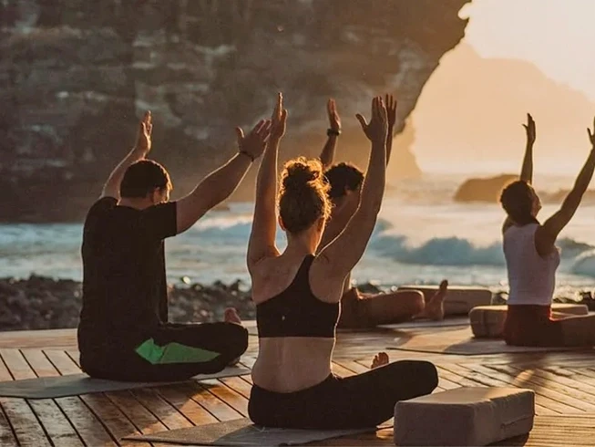 Seaside yoga retreat blending daily movement, rooftop pool living, local culture, island escapes, and shared meals.