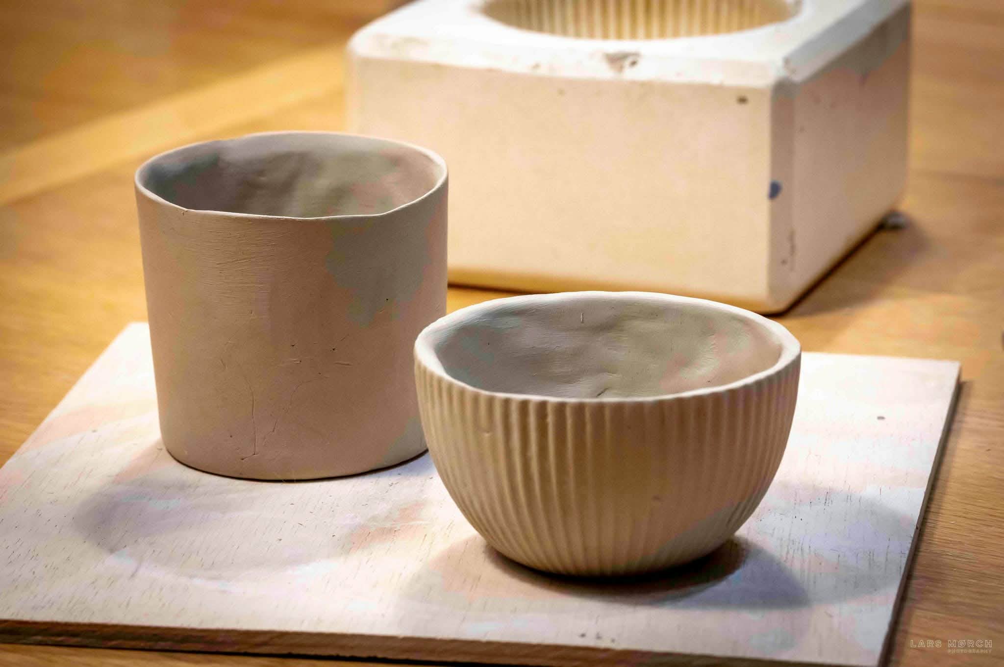two greenware cups obtained using casting moulds
