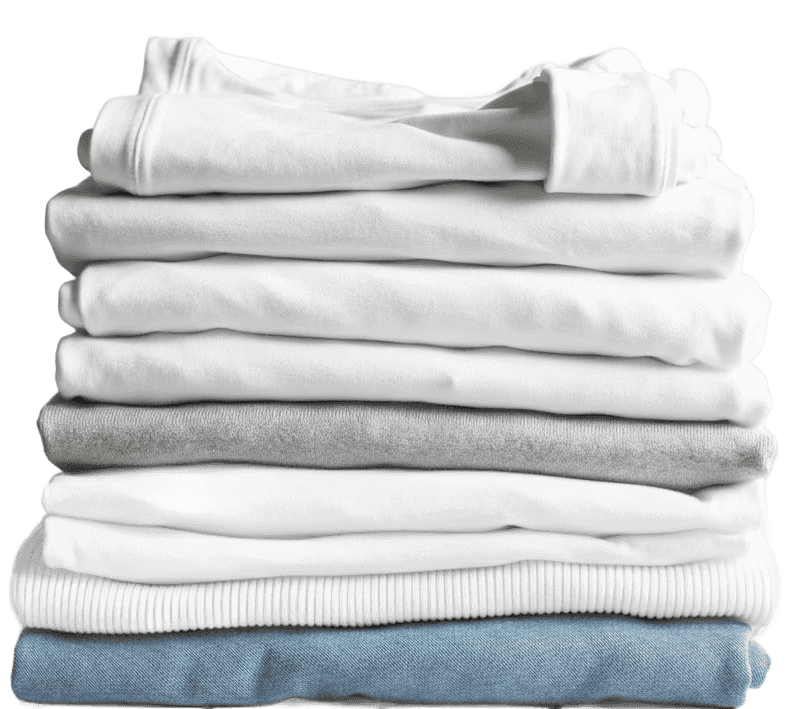 folded clean white laundry stacked up on a white oak table