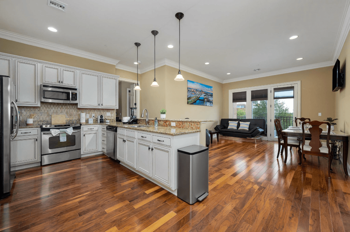 Spacious open-concept kitchen and living area at The Gateway Village with luxury finishes and hardwood flooring, offering comfortable, easy single-level living.