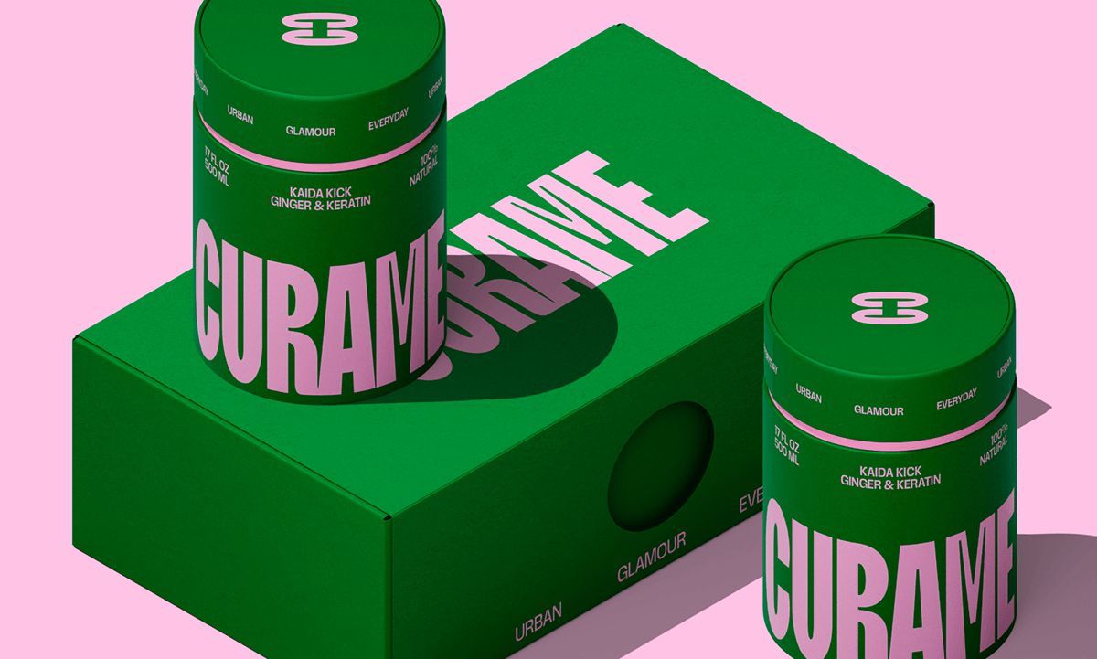 A modern brick house with a two-car garage, well-manicured lawn, and clear blue sky in the background.