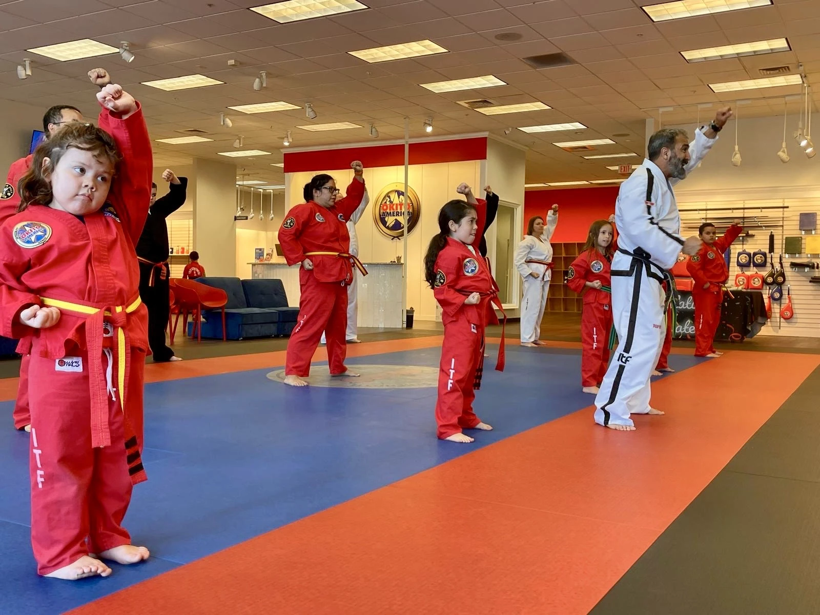 Groups attendees looking at the instructor of a Taekwondo class.