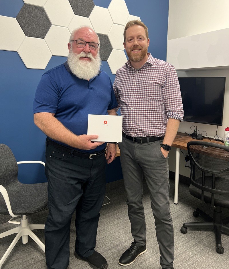 woman lying on white flooring holding grapes beside apple fruits