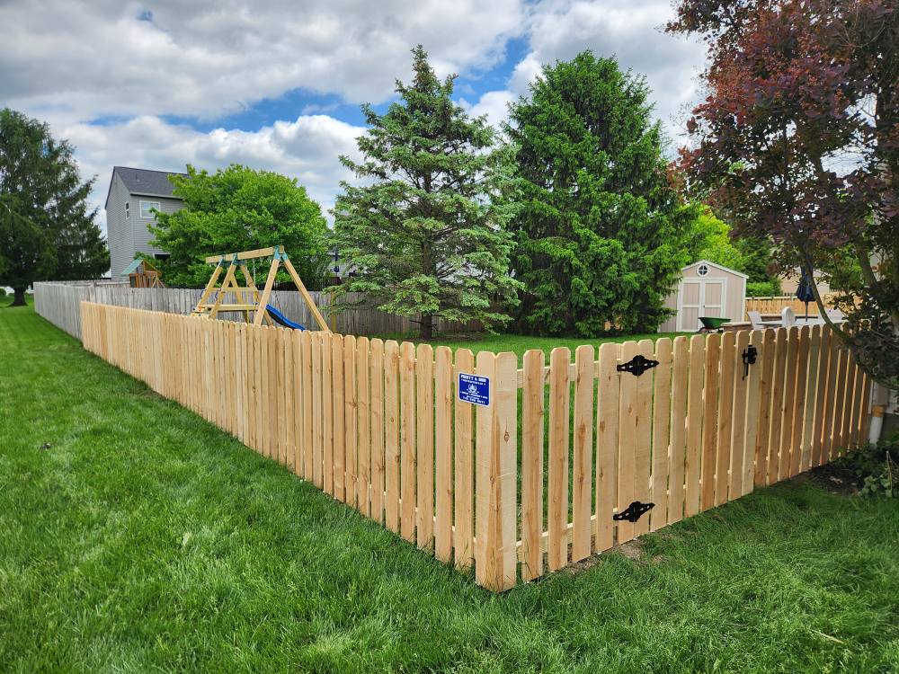 Spacious, luxurious living room with high ceilings, an elegant beige sectional sofa, warm ambient lighting, classical artwork, and rustic architectural elements, featuring an open layout with a view of a mezzanine level.