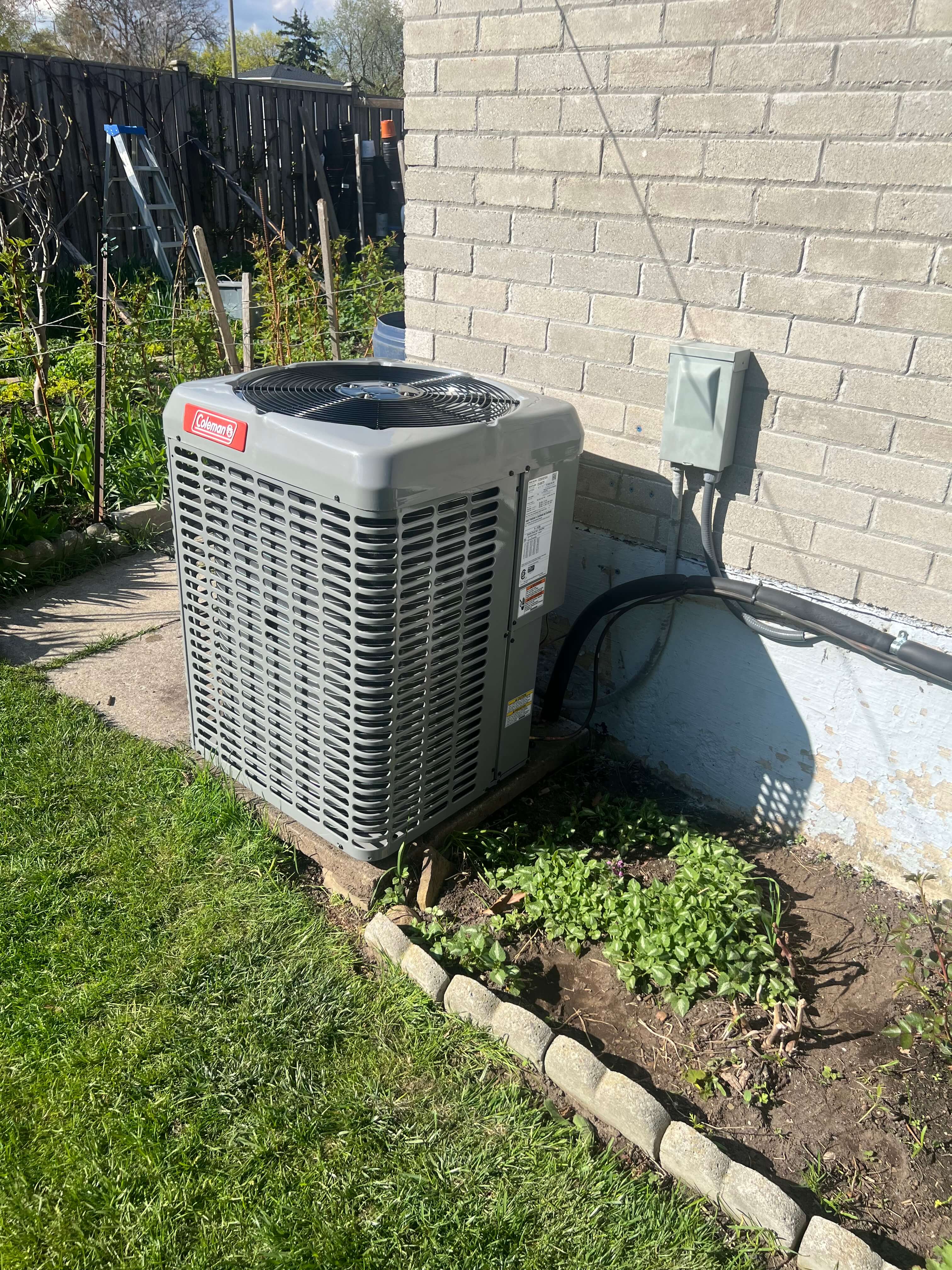 Air conditioner installed in a backyard in Burlington