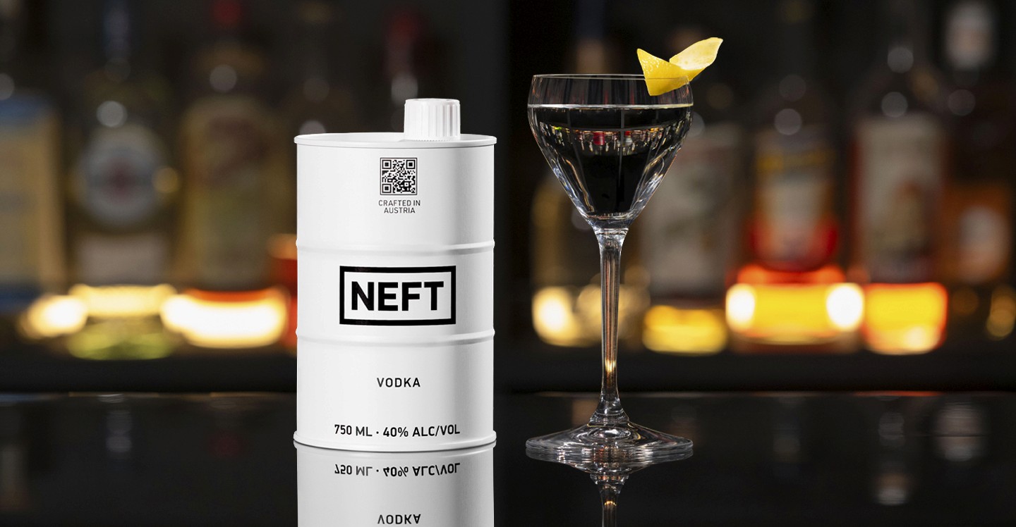 A NEFT Barrel and a glass of Vodka Martini on a bar counter.