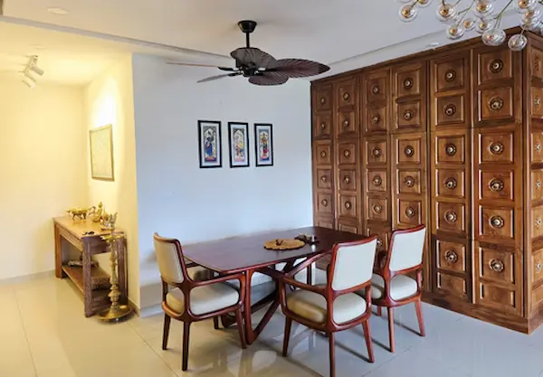 Contemporary wooden dining table paired with cushioned chairs in a refined setting