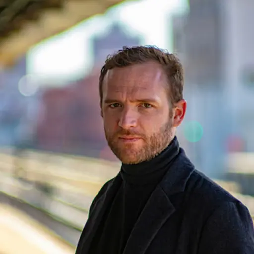 man wearing black notched lapel suit jacket