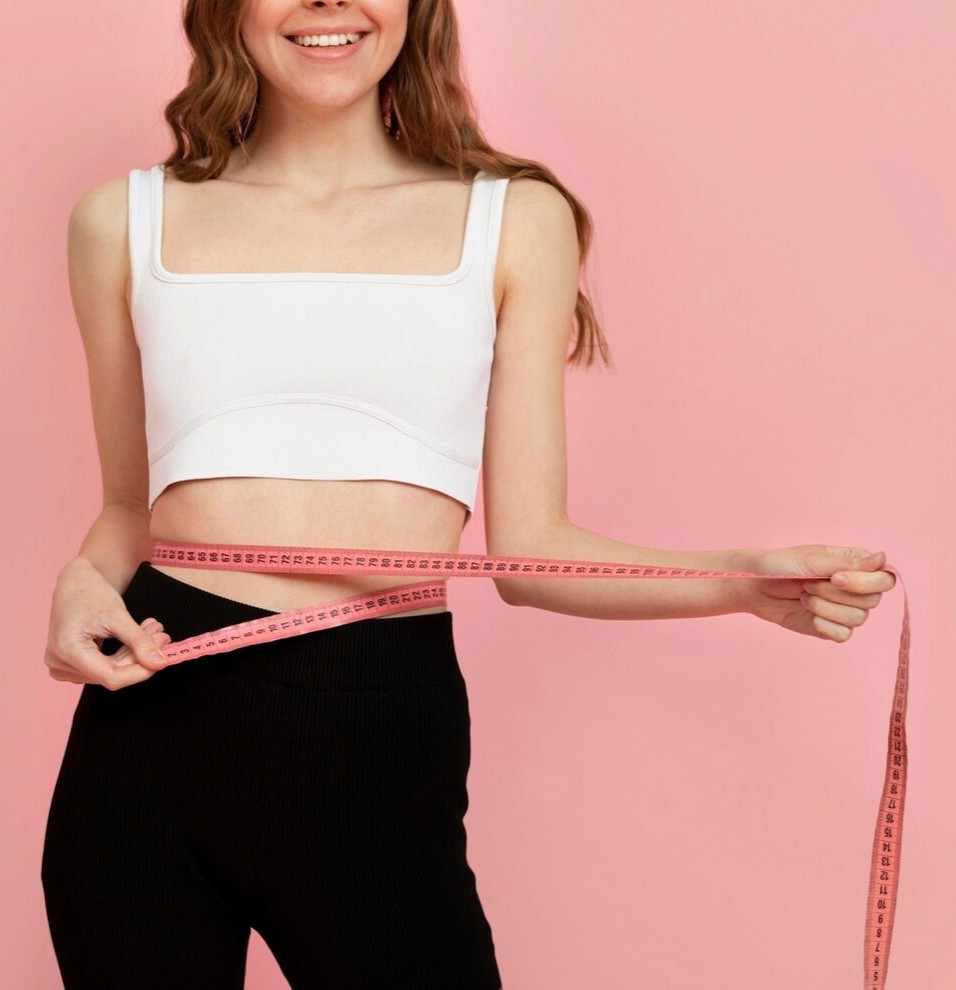 woman measuring waistline