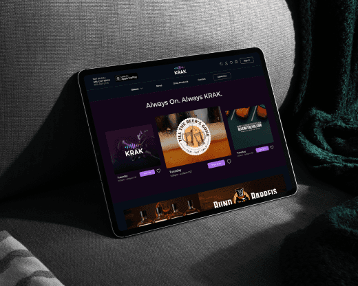 Custom sound wave icon in vibrant blue, pink, and purple over black background. Krak media platform interface displayed on a tablet and hands holding a tablet showing the neon-lit website.