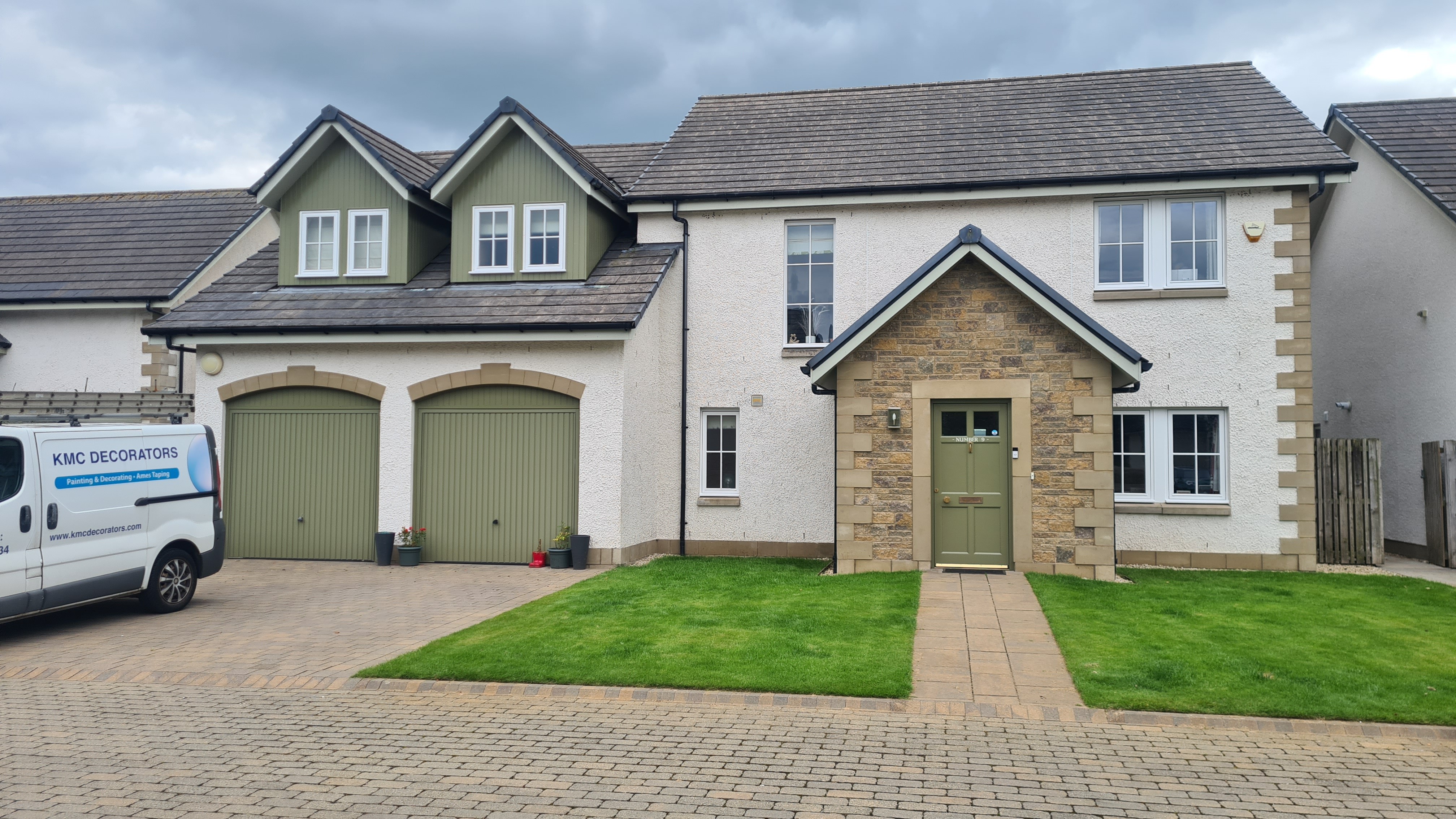 Large 2 story house with driveway and front garden