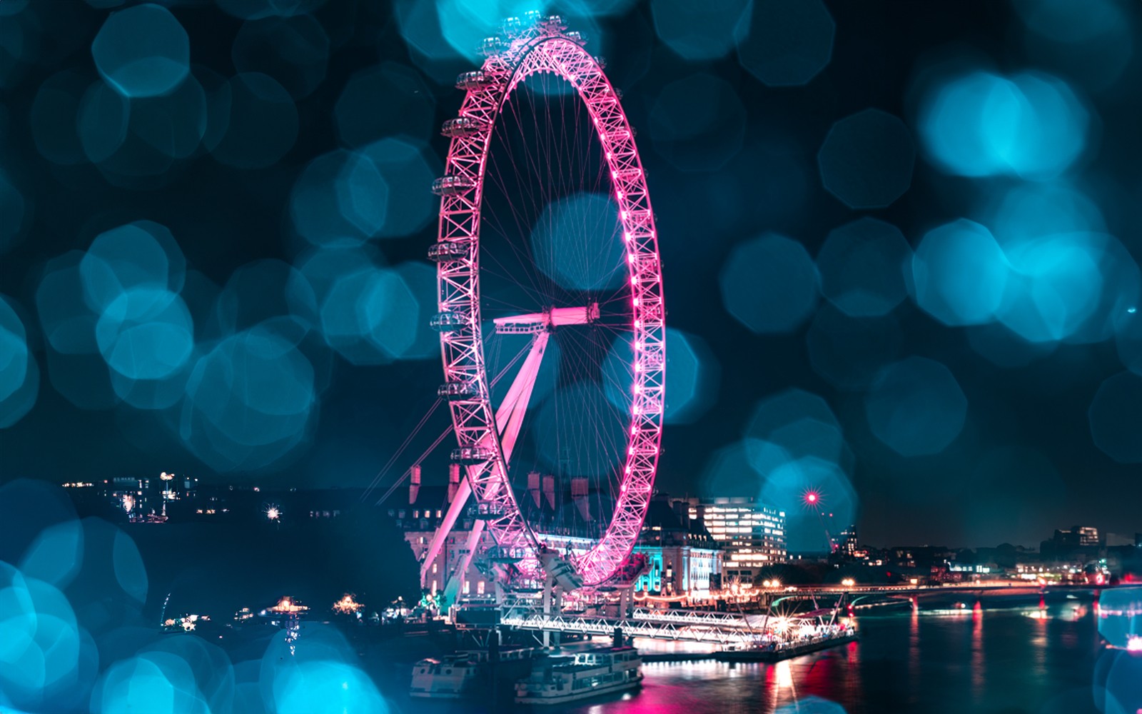 London Eye lit up at night during Christmas, viewed from the Thames, part of The Original Tour London 24Hr Pass.