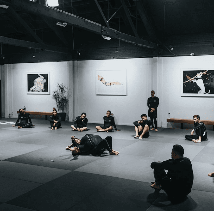 Minimalist gym equipment including a kettlebell and medicine ball on a wooden box.