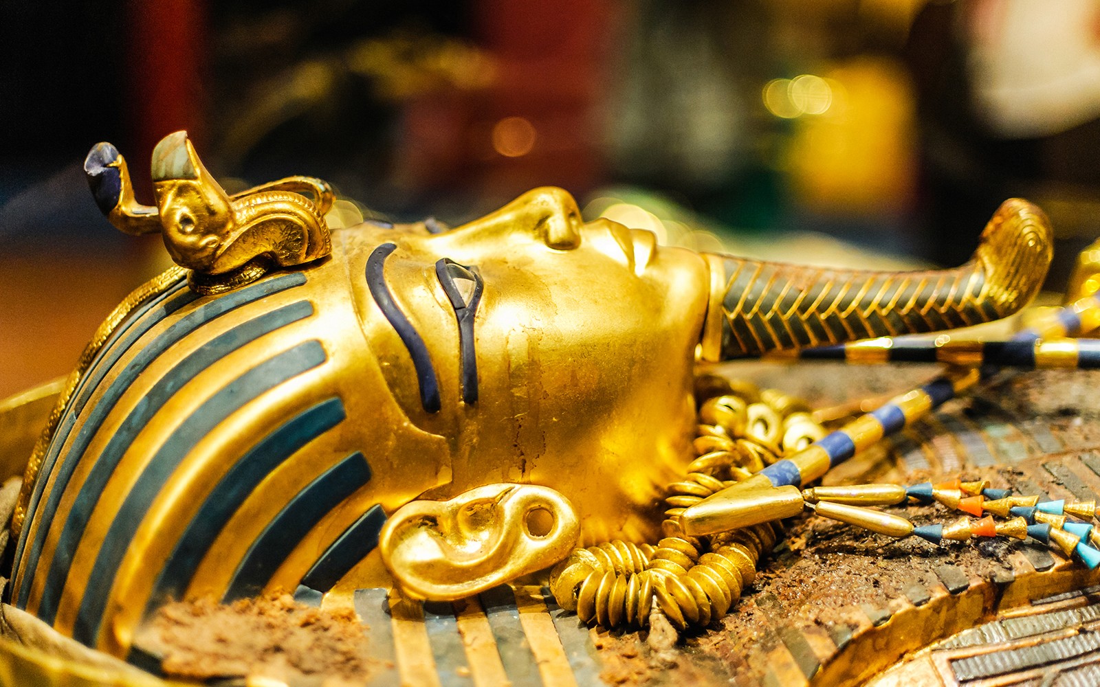 Tutankhamun's golden mask with intricate blue and gold detailing.