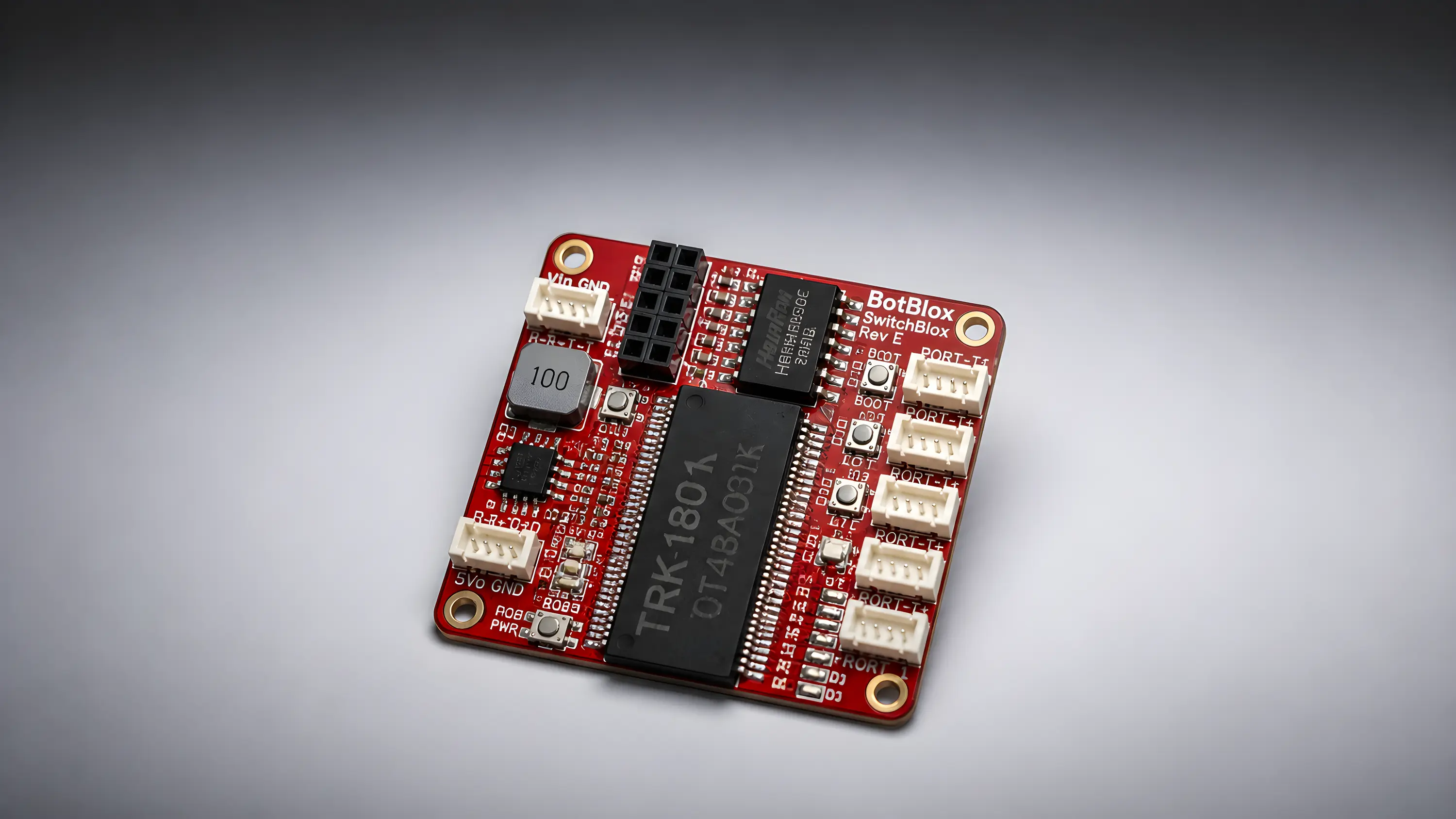 BotBlox SwitchBlox Rev E five-port Ethernet switch board photographed on a grey studio background