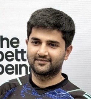 man in gray crew neck t-shirt and gray shorts sitting on basketball court