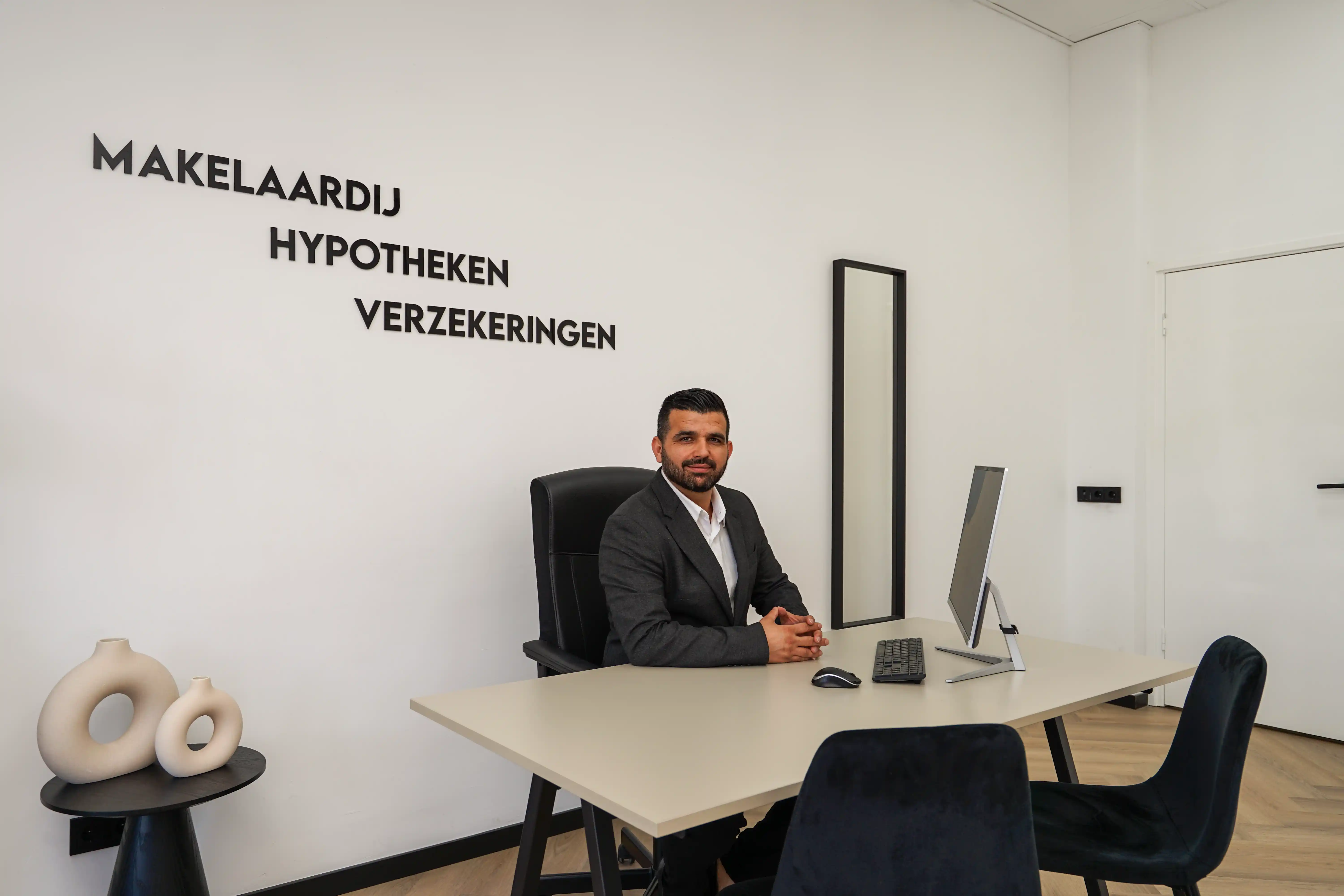 Selcuk Aksoy aan zijn bureau in het kantoor van ON Makelaardij Den Haag