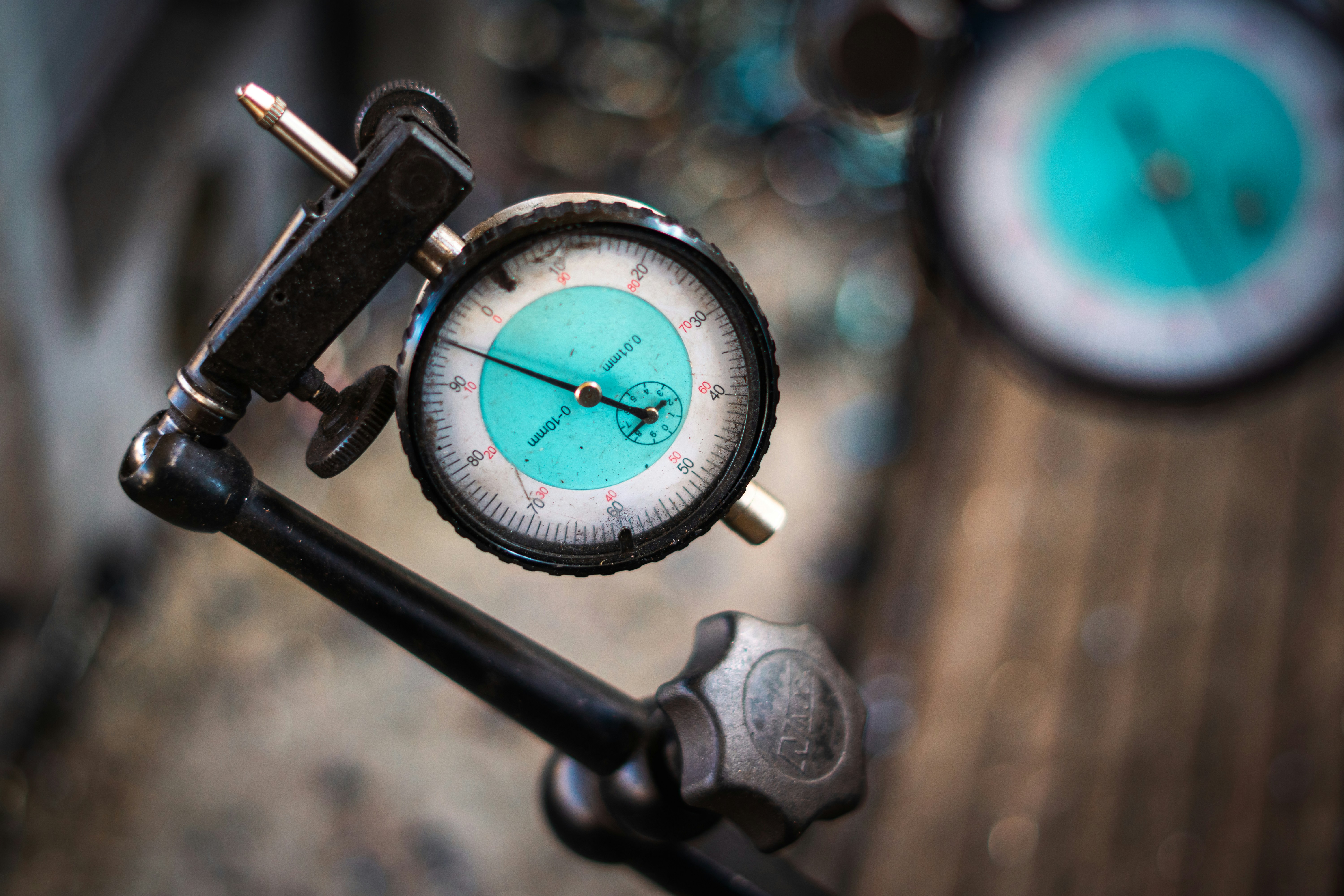 A close up of a clock on a piece of wood