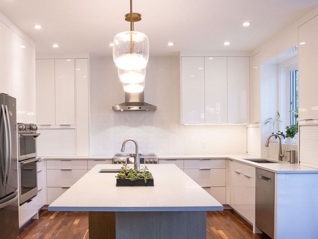 Image of Modern kitchen design with island, white cabinets, and stainless steel appliances by KHD Homes.