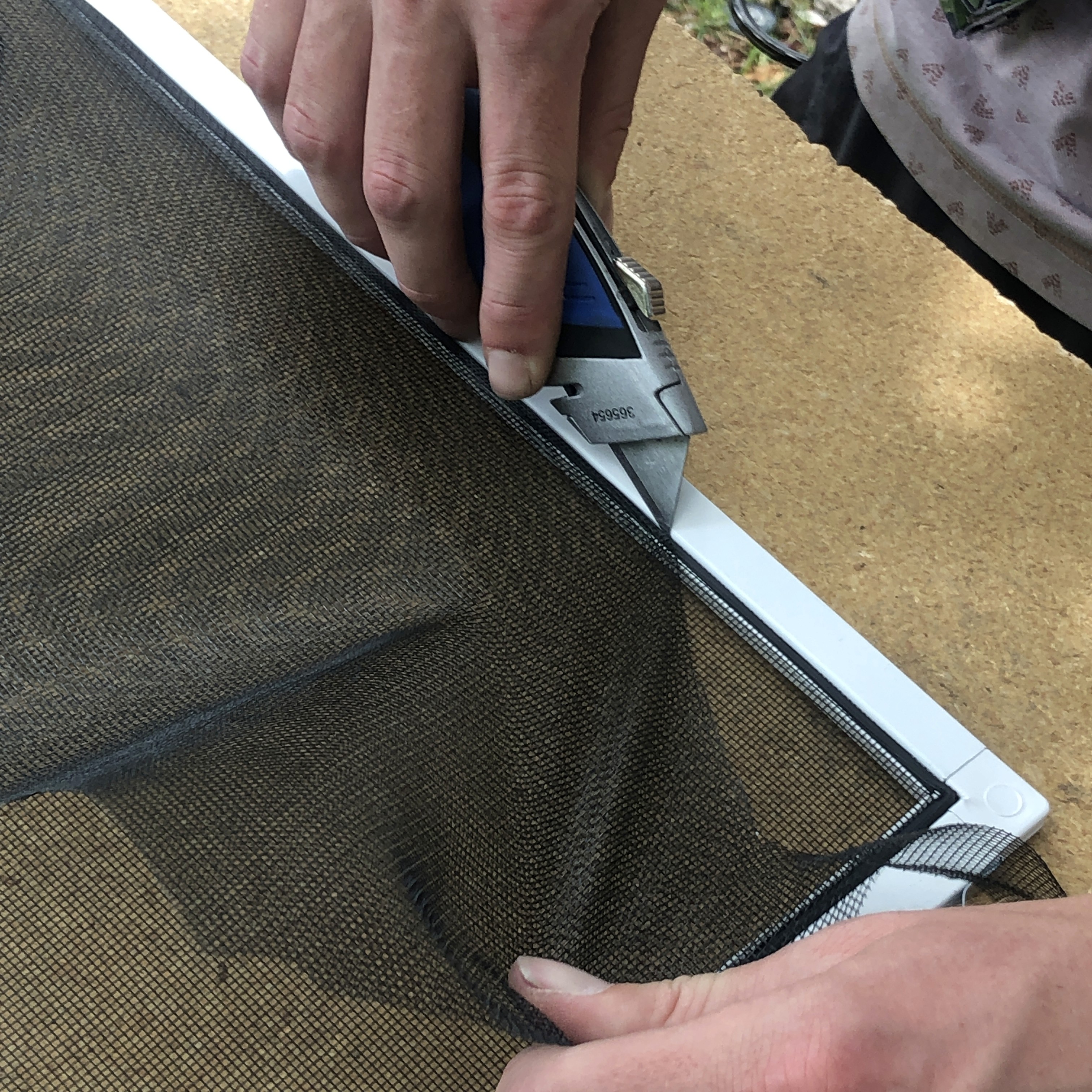 Window screen frame and spline on a workbench, showing our screen assembly process.