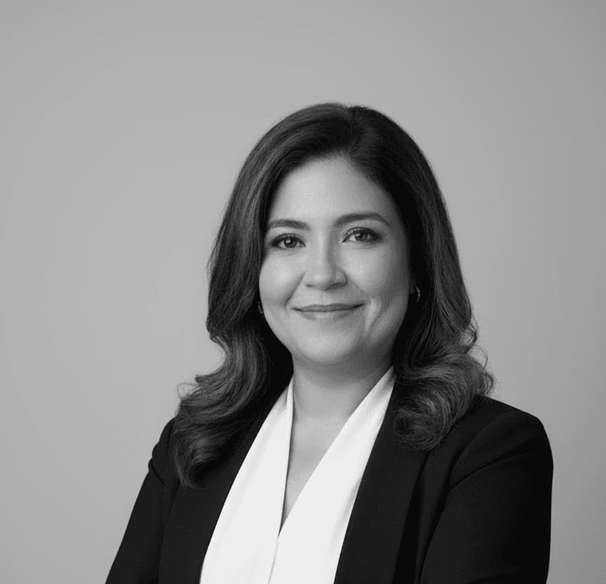 Monochrome product shot: black-capped cosmetic bottle with dynamic water splash on a clean white background.