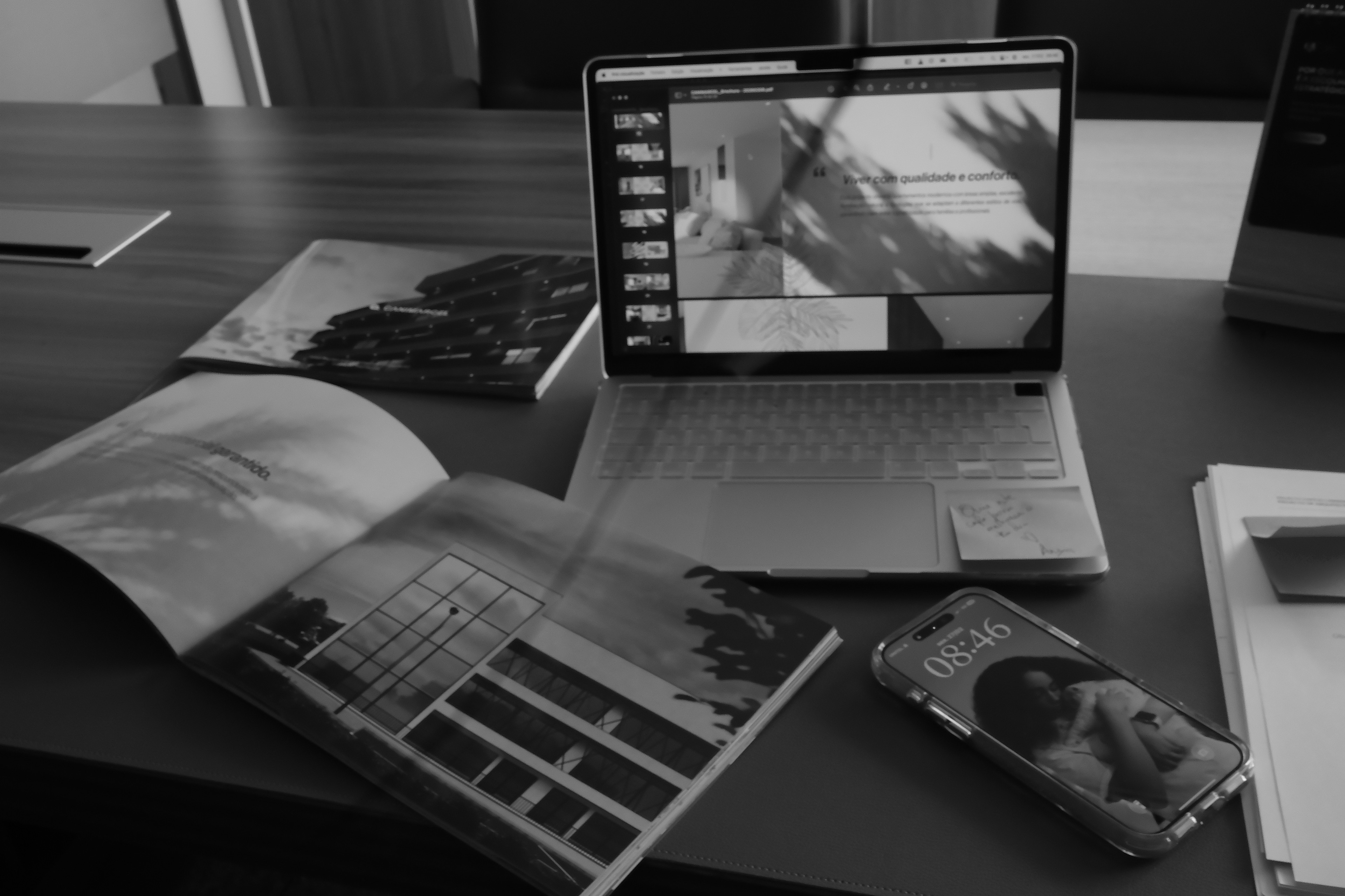 Black and white photo of a work secretary with photos and work.