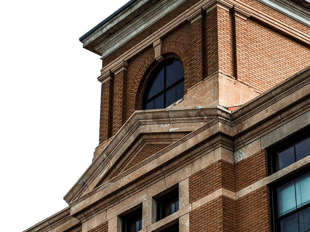 Historic brick building facade with arched windows and detailed architecture.